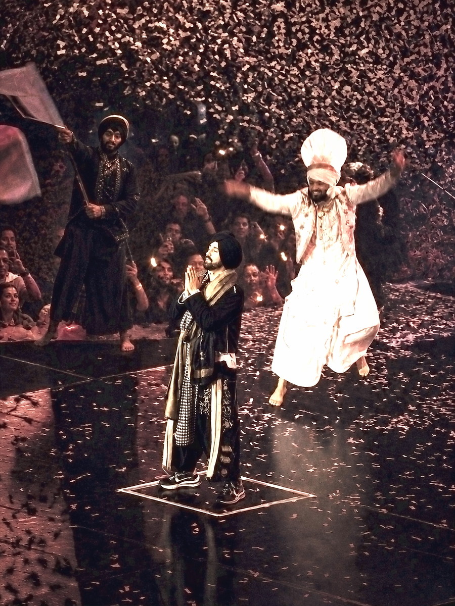 Two performers on a stage amid falling confetti