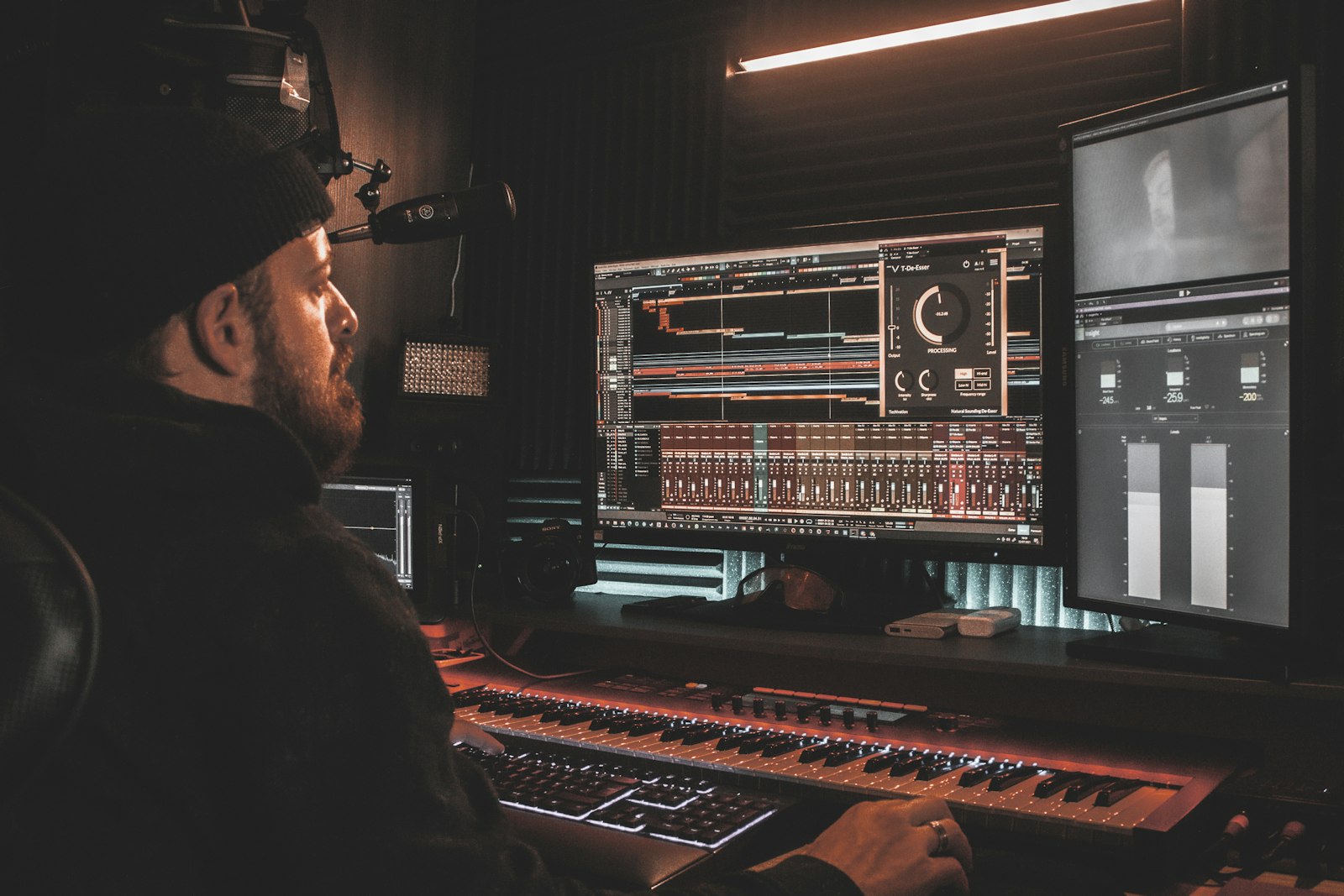 Hands working an audio mixing desk