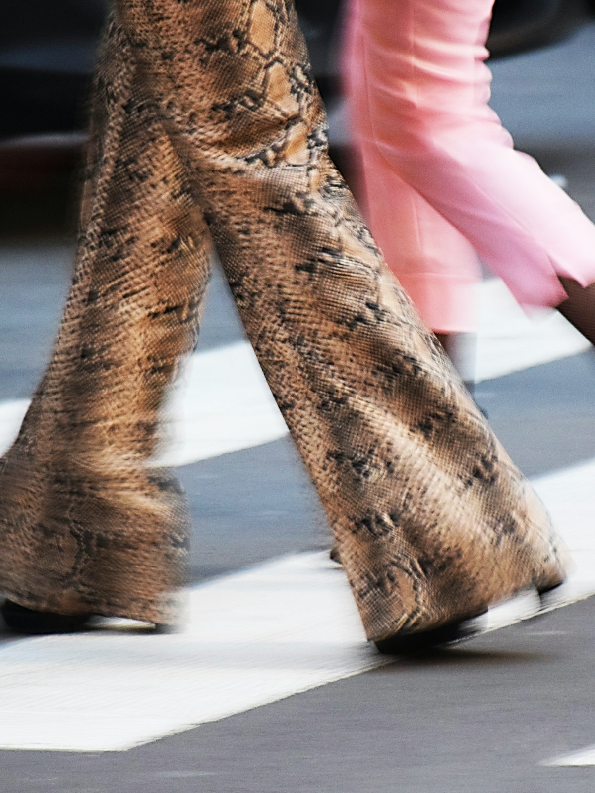 Close crop of patterned trousers, fabric and stitching filling the frame