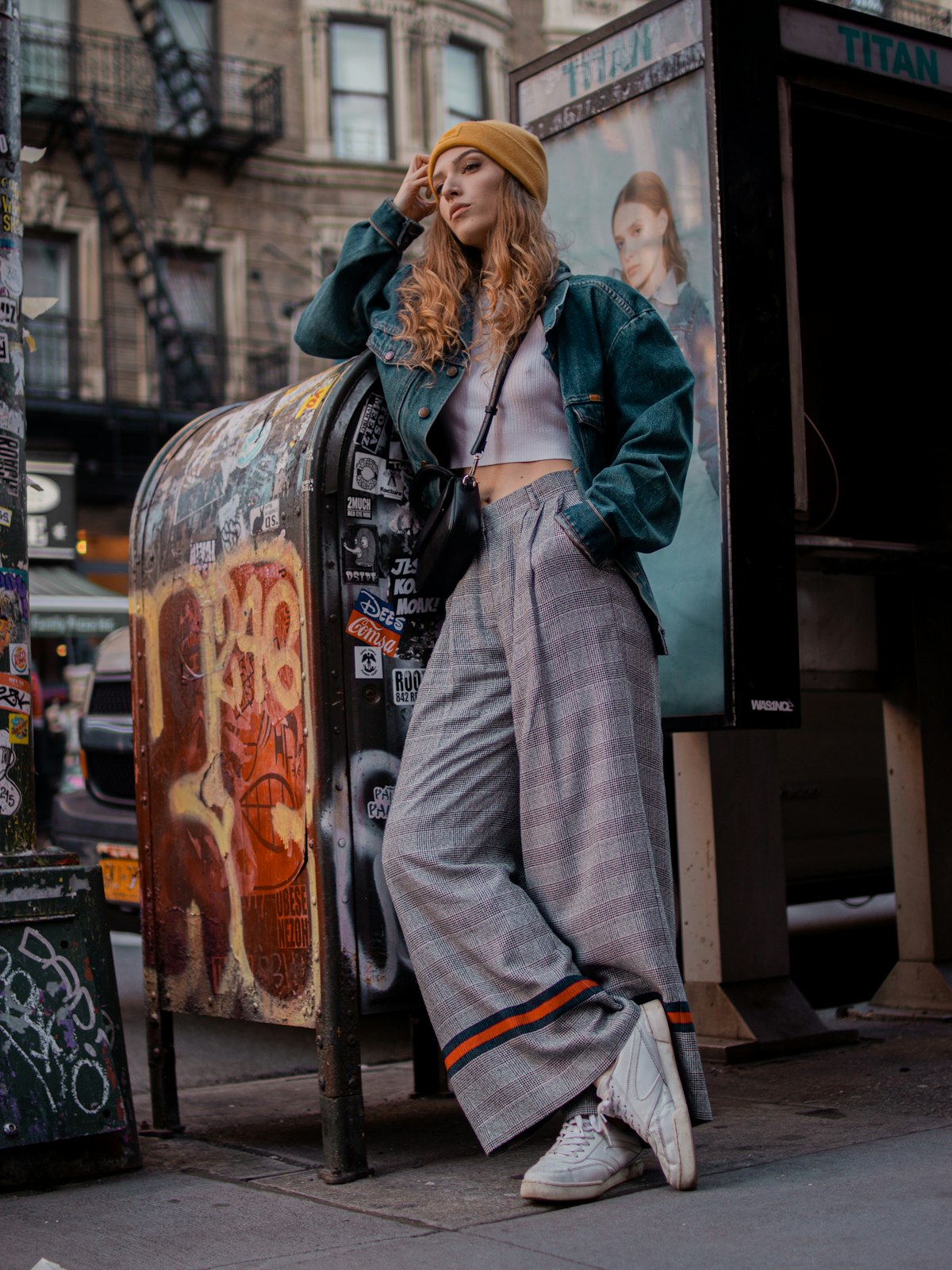 Full-length street look, grey coat, standing beside a vending machine